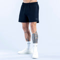 Dark athletic shorts with elastic waistband and small side logo, knee-length.