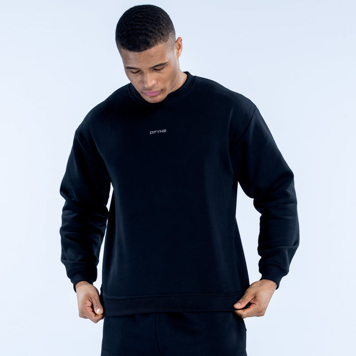 Black crewneck sweatshirt with chest logo and ribbed cuffs, front view
