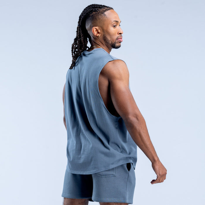 Blue sleeveless tank top, side view, crew neck and relaxed fit
