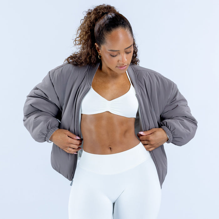 Reversible bomber jacket in dark gray with front zipper, open at the chest