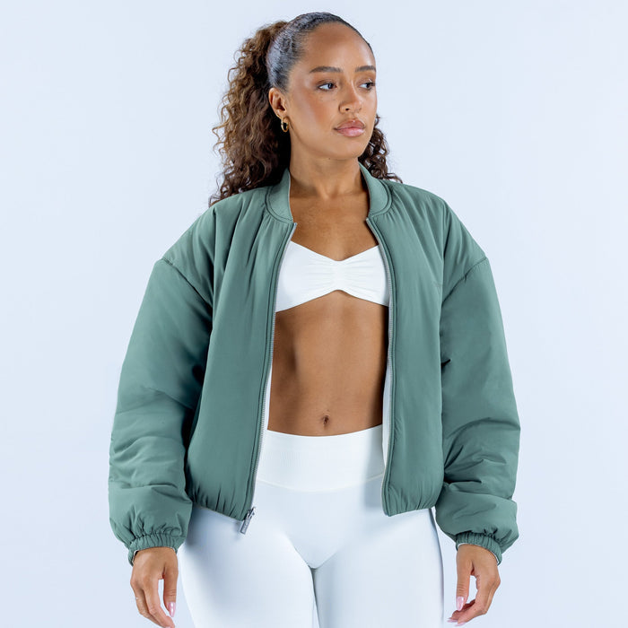 Green reversible bomber jacket with stand collar, zipper front, and gathered cuffs