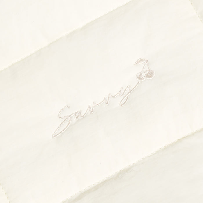 Sav puffer bag with embroidered 'Sav' script logo on ivory fabric