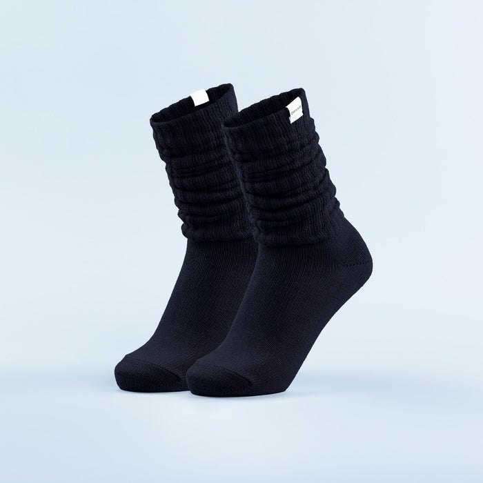 Black scrunch ankle socks with gathered ribbed cuffs and seamless toe.