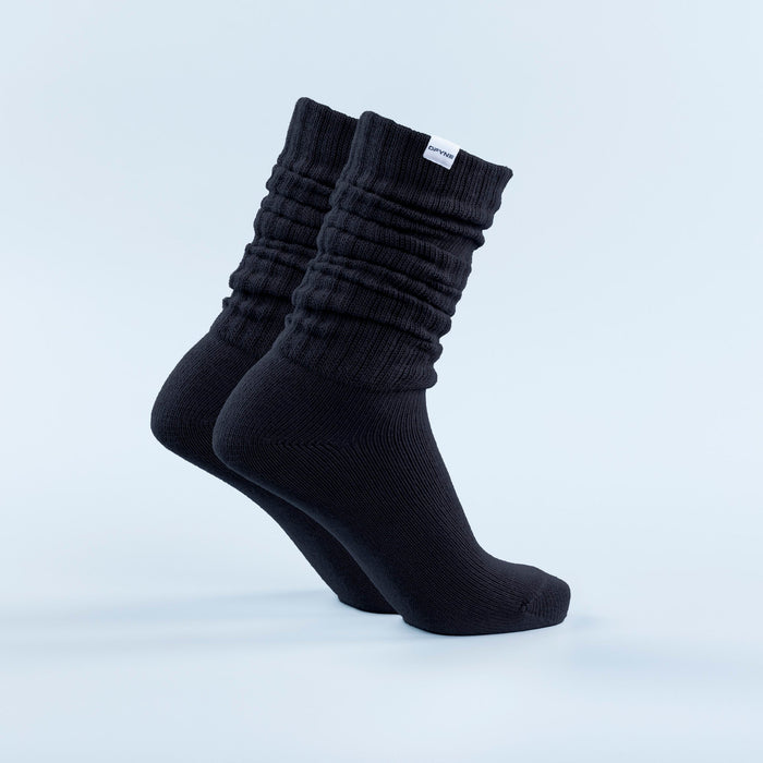 Black scrunch ankle socks with ribbed cuff texture and cushioned knit foot.