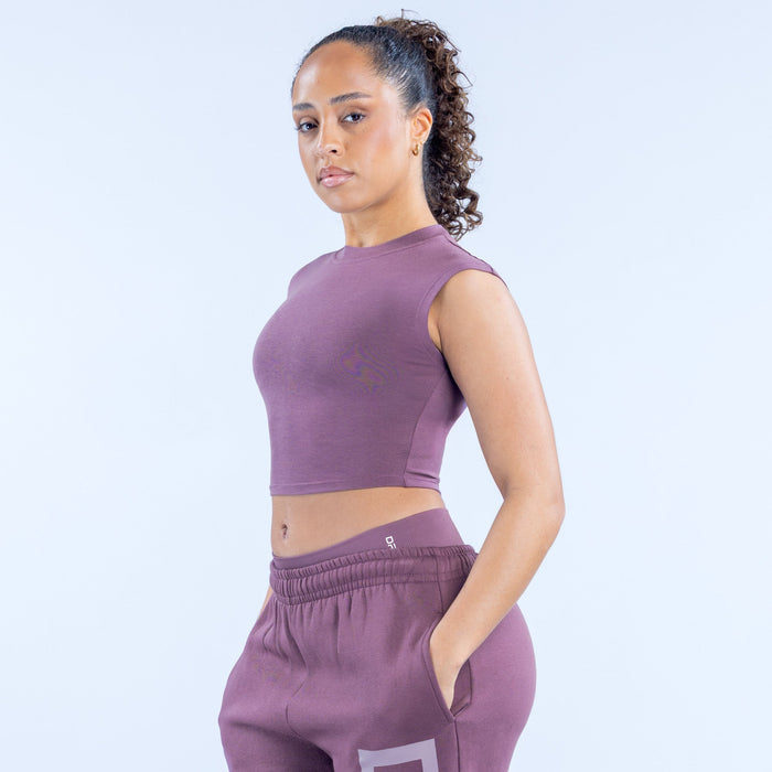 Purple sleeveless crop baby tee with crew neck and small left-chest logo