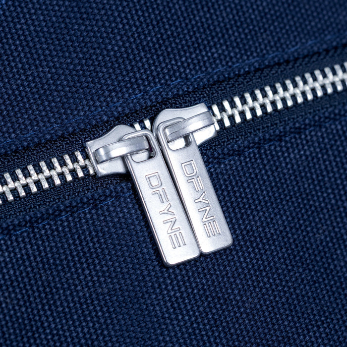 Navy duffle bag zipper with silver double pull tabs and engraved D-FYNE branding