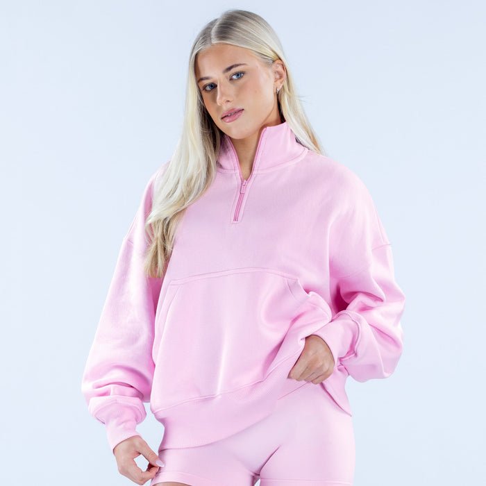 Pink quarter-zip sweatshirt with half-placket, kangaroo pocket, and long sleeves
