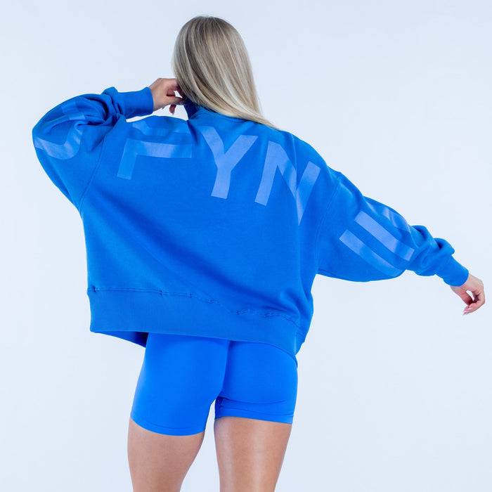 Blue quarter-zip sweatshirt, back view with kangaroo pocket and ribbed cuffs