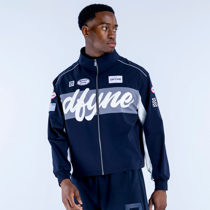 Men's navy track jacket with white script graphic panel, stand collar, zip