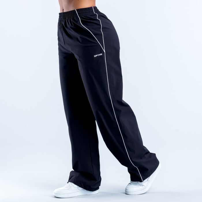 Men's dark track pants with elastic waist and white side stripe, tapered leg