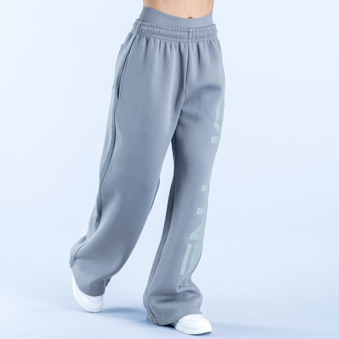 Light gray wide-leg jogger pants with side graphic logo and relaxed cuffed hems