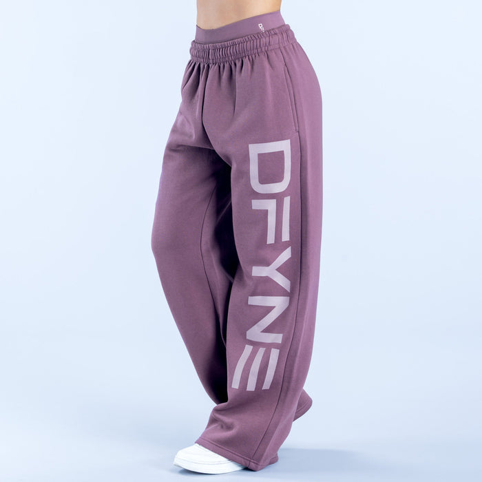Purple wide-leg jogger pants with elastic waistband and bold vertical logo detail