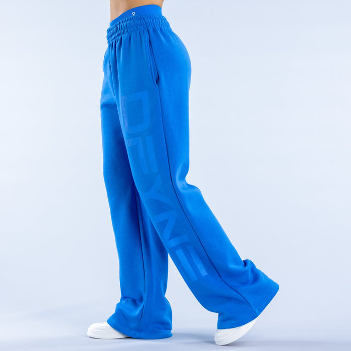 Blue wide-leg jogger pants with elastic waist and vertical logo graphic