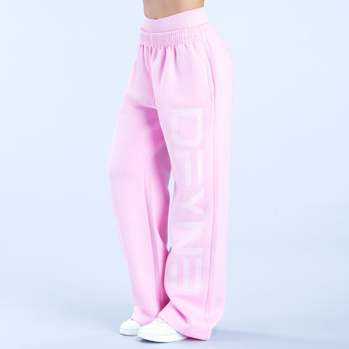 Pink wide-leg jogger pants with elastic waistband and large vertical logo graphic on leg.
