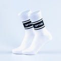 Pair of white crew sports socks with black stripe logo on cuff