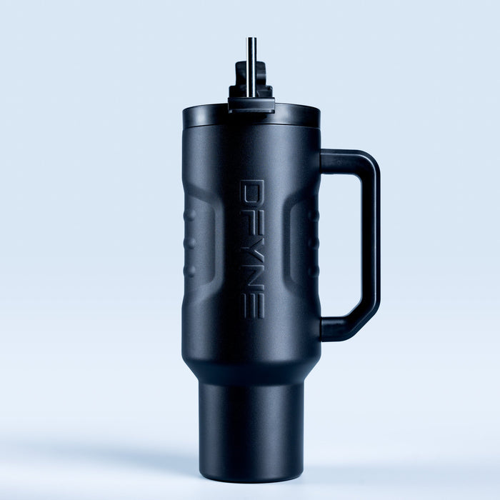Insulated black drink tumbler with handle and straw, side view