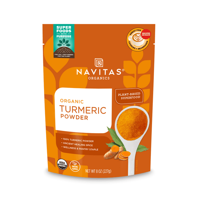 A package of Navitas Organics Superfoods Turmeric Powder, featuring a USDA Organic and Non-GMO Verified seal, with an image of a spoonful of turmeric and a plant-based icon on the front.