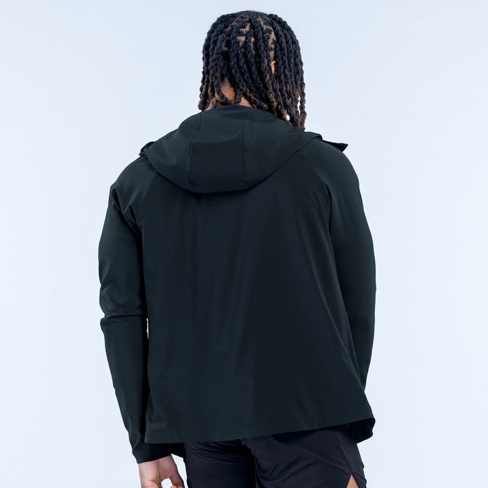 Back view of Unbound jacket, dark hooded windbreaker with zip front