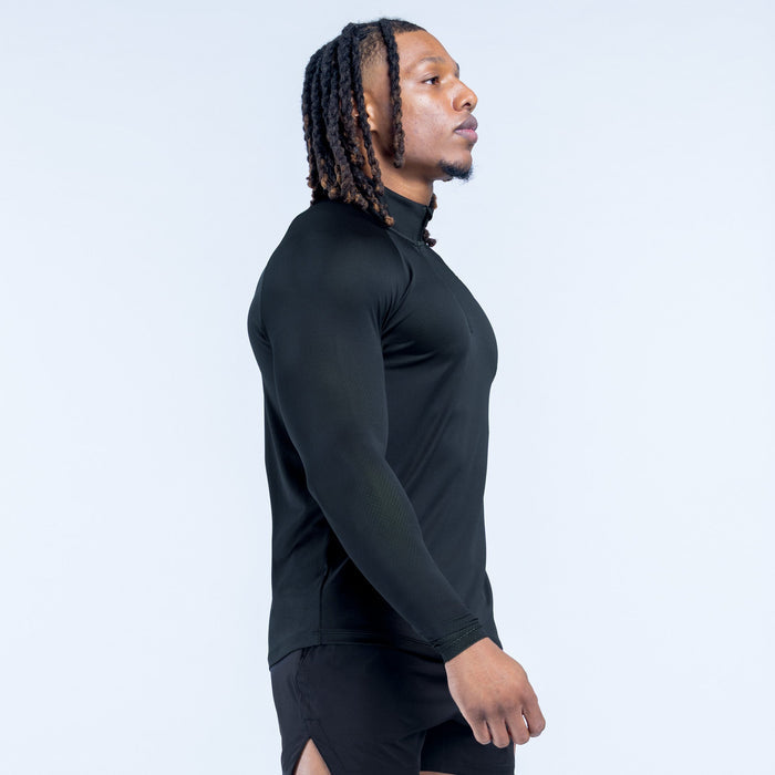 Black quarter-zip athletic top, side view with long sleeves and logo hem