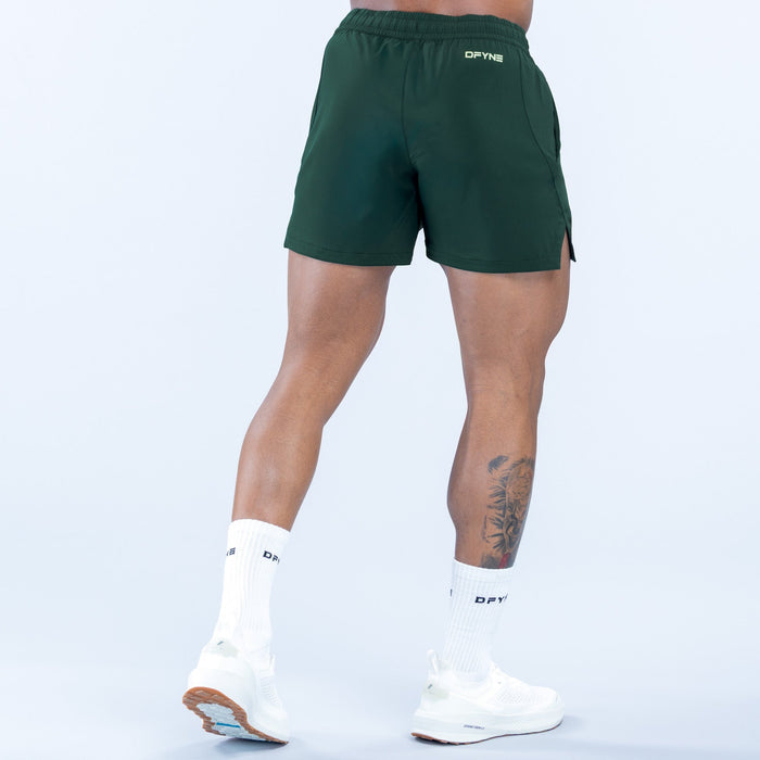 Green training shorts, small logo on back, knee-length with side vents