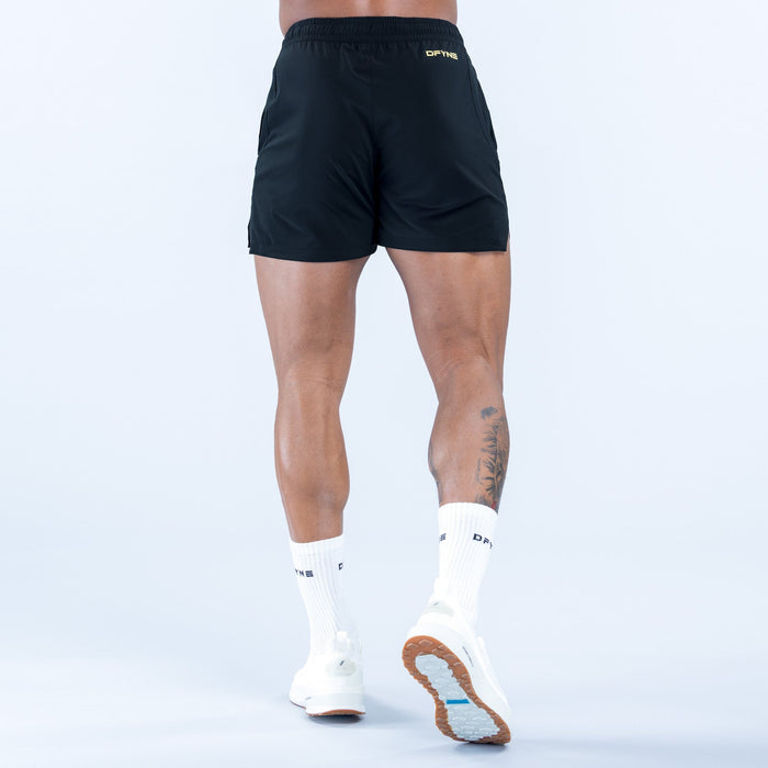 Men's black training shorts, back view, elastic waist with small logo