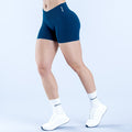 4.5-inch performance shorts in dark teal, side view, mid-thigh length.