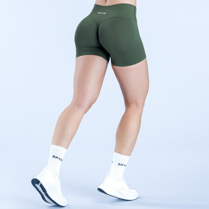 Dark green 4.5 in athletic shorts with curved seam and small back logo