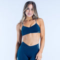 Dark blue strappy sports bra with small front logo and V-neck front