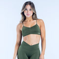 Olive green strappy sports bra with thin adjustable straps and V neckline
