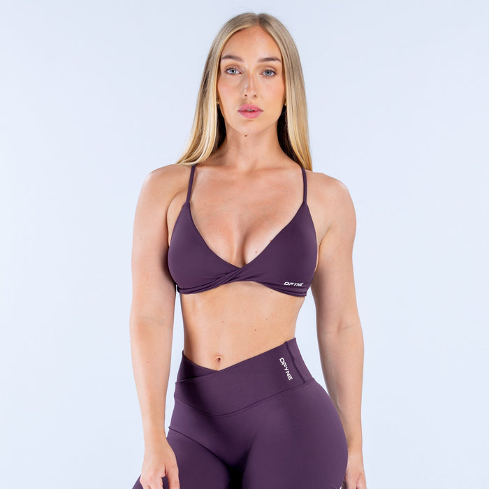 Dark purple twist-front sports bra with V neckline and elastic underband
