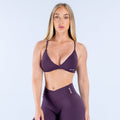 Dark purple twist-front sports bra with V neckline and elastic underband